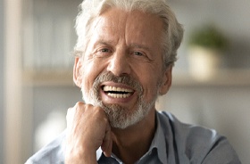 Happy senior man with implant dentures in Lebanon