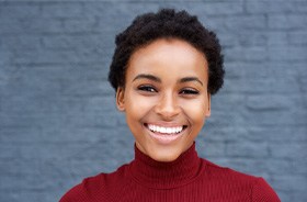 Confident, smiling woman in red turtleneck