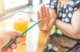 Woman saying no to drinking straws after dental implant surgery
