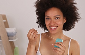 woman flossing teeth