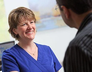 Dental team member smiling at dental patient