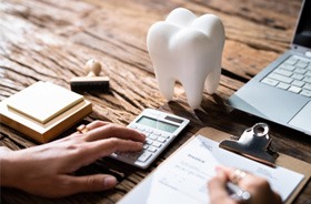 Using calculator to budget the cost of dental care