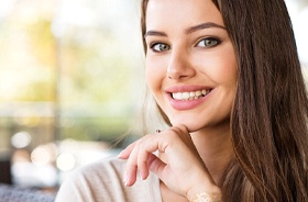 Woman with beautiful, happy smile after corrective jaw surgery