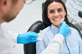 Happy dental patient getting shade-matched for dental crown