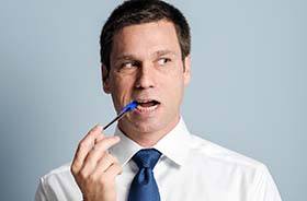 Man chewing on pen headed for dental emergencies in Lebanon 