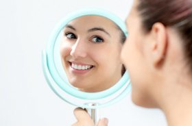 woman smiling in mirror