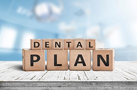 Dental plan written on wooden blocks, arranged on tabletop