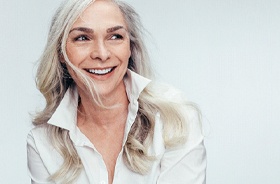 Attractive senior woman enjoying the benefits of implant dentures