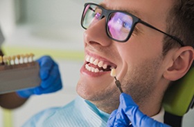 Man smiles while getting dental implants in Lebanon