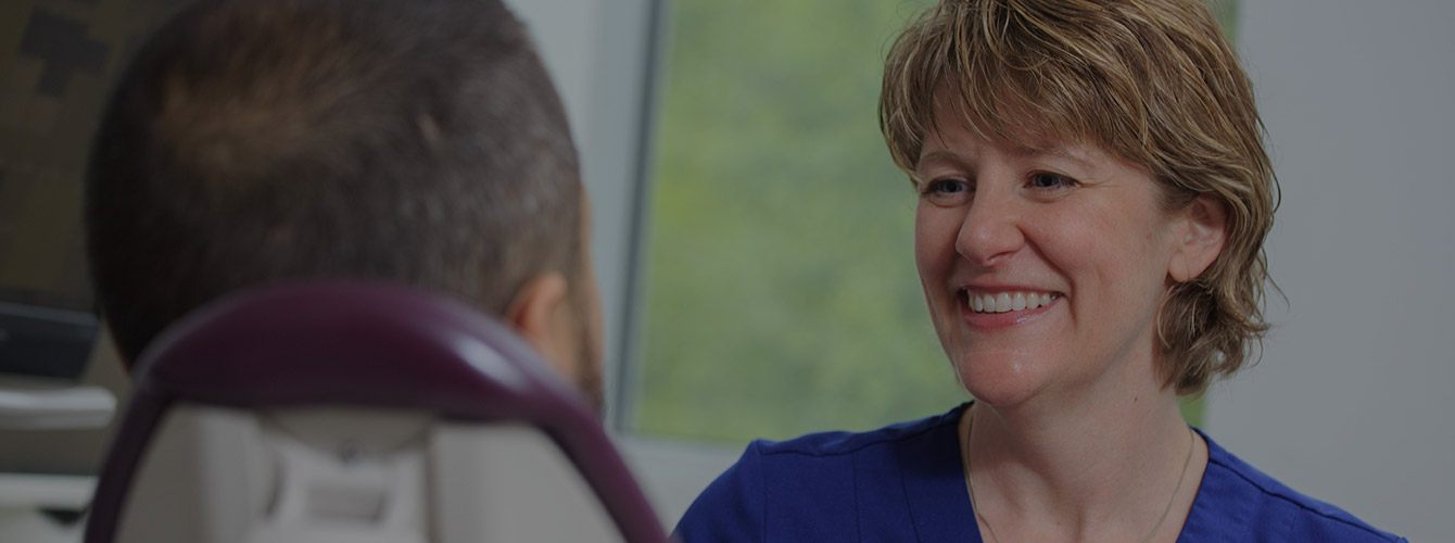 Dentist smiling at dental patient