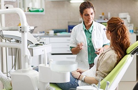 Dental patient conversing with dentist