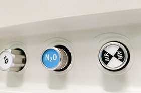 Close-up of three control dials on nitrous oxide machine