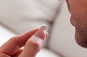 Patient taking an antibiotic pill