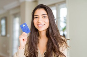 Smiling woman holding a payment card