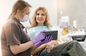 Smiling patient talking with dental team member