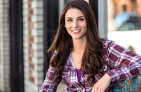 Woman with perfect teeth, happy she could afford veneers