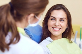 Dentist and happy patient discussing cosmetic dentistry treatments