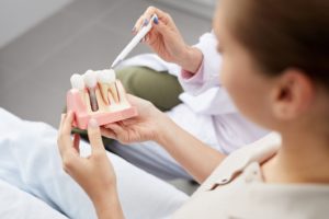 dentist and patient discussing dental implants as tooth replacement solution