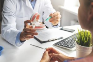 Dentist explaining need for bone graft in Lebanon