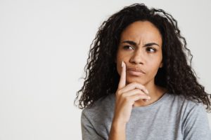 Frowning woman, wondering about a bump on her gums in Lebanon