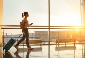 Woman with suitcase walking through airport