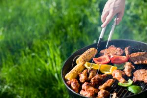 Tasty summer foods cooking on grill