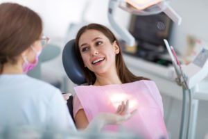 Female dental patient talking with dentist