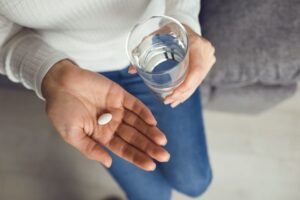 Woman preparing to swallow a sedative pill 