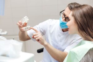 Dentist and patient talking about dental implants 