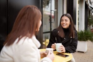 Two friends talking over coffee